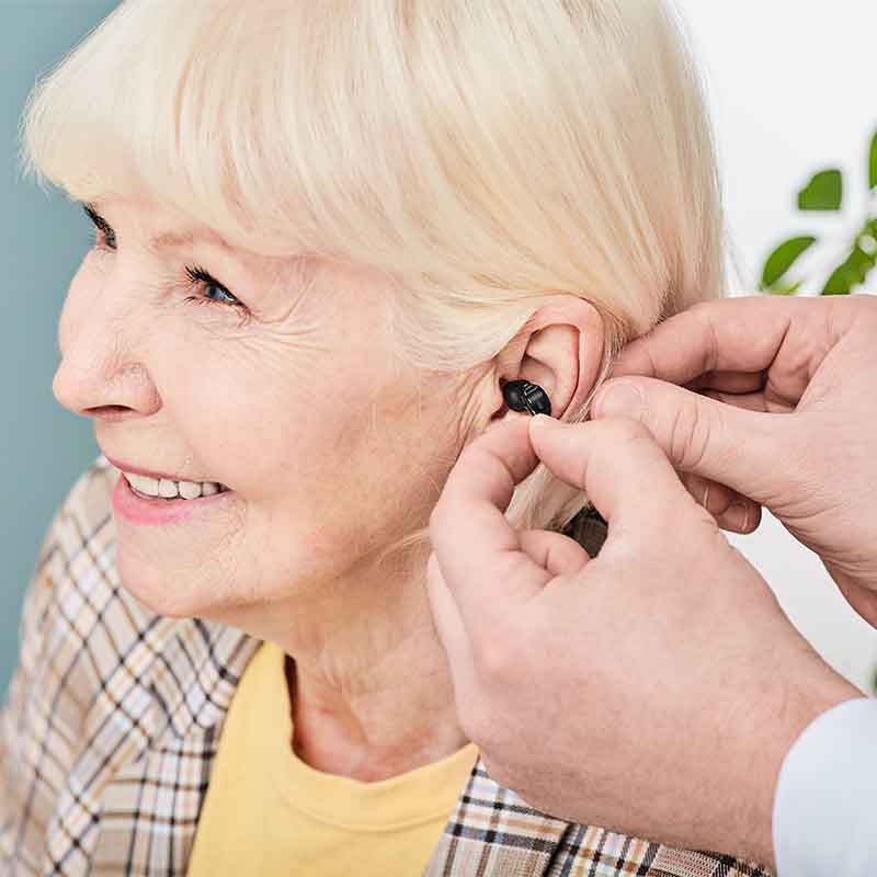 Woman being fitted for a discreet hearing aid